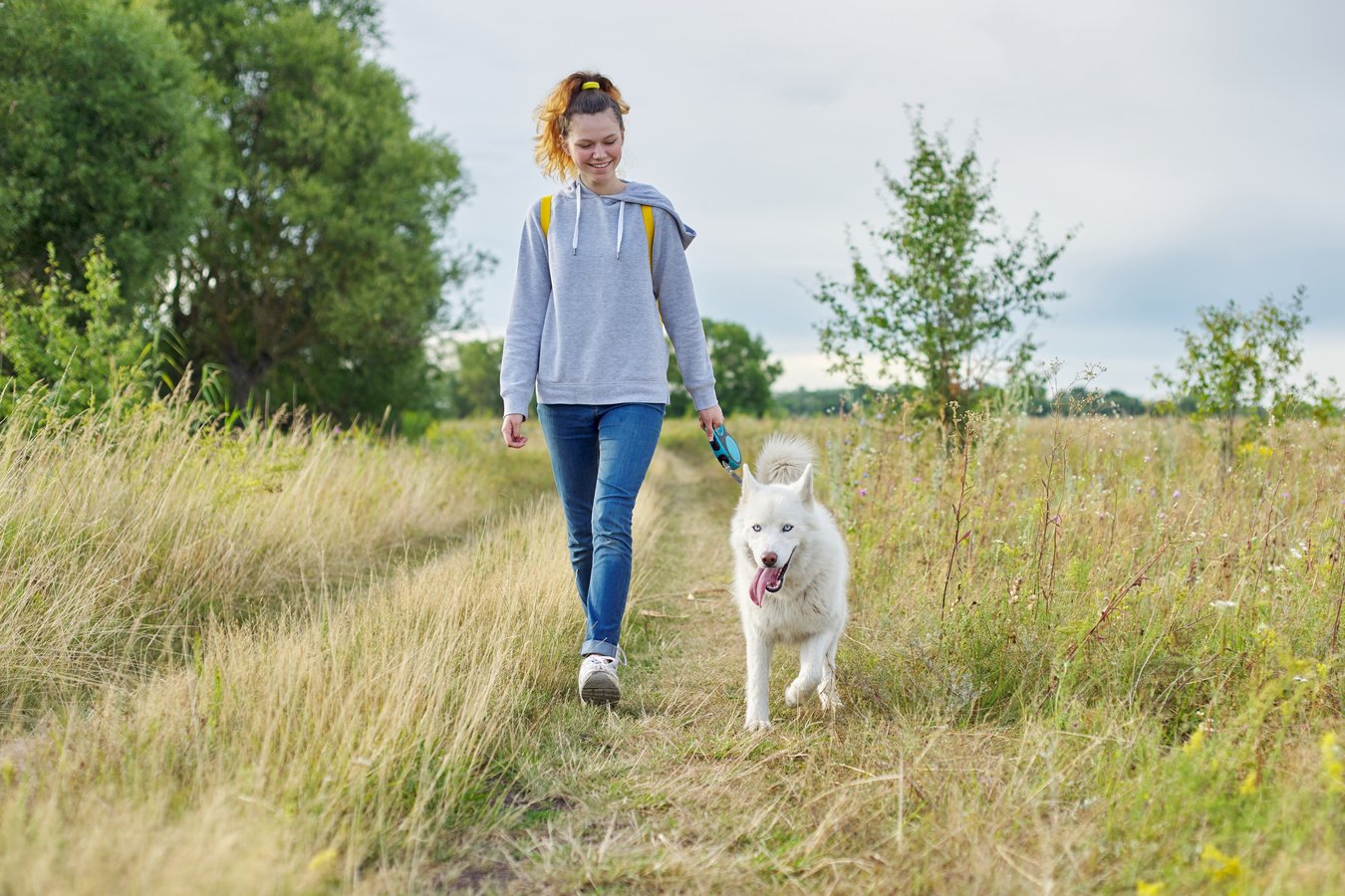 Woman Walking Dog in Nature